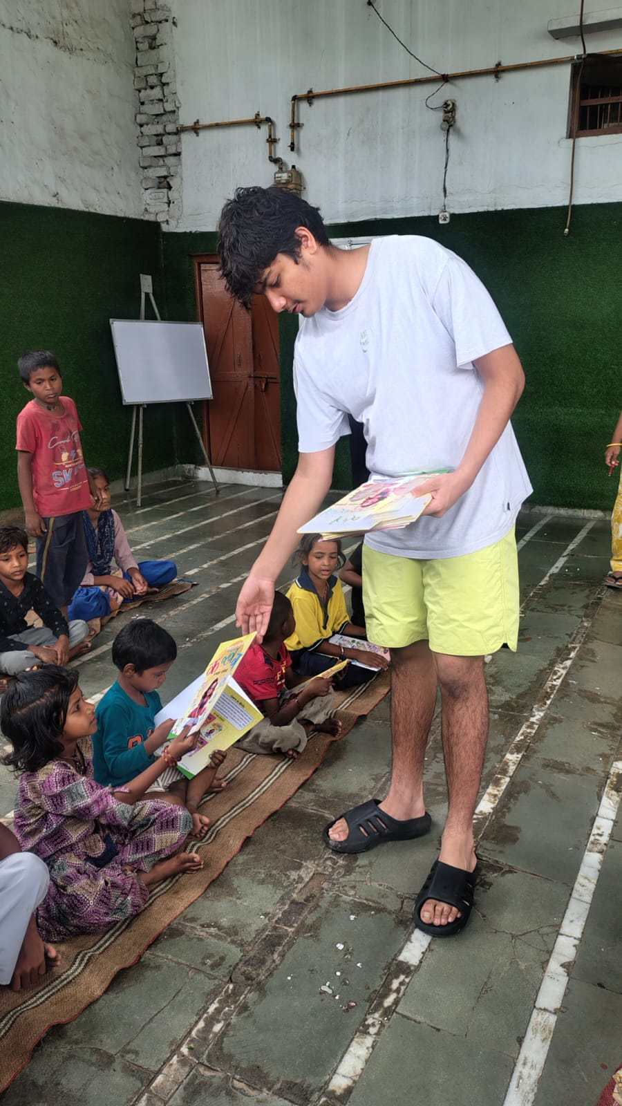 Handing out new picture books to the children